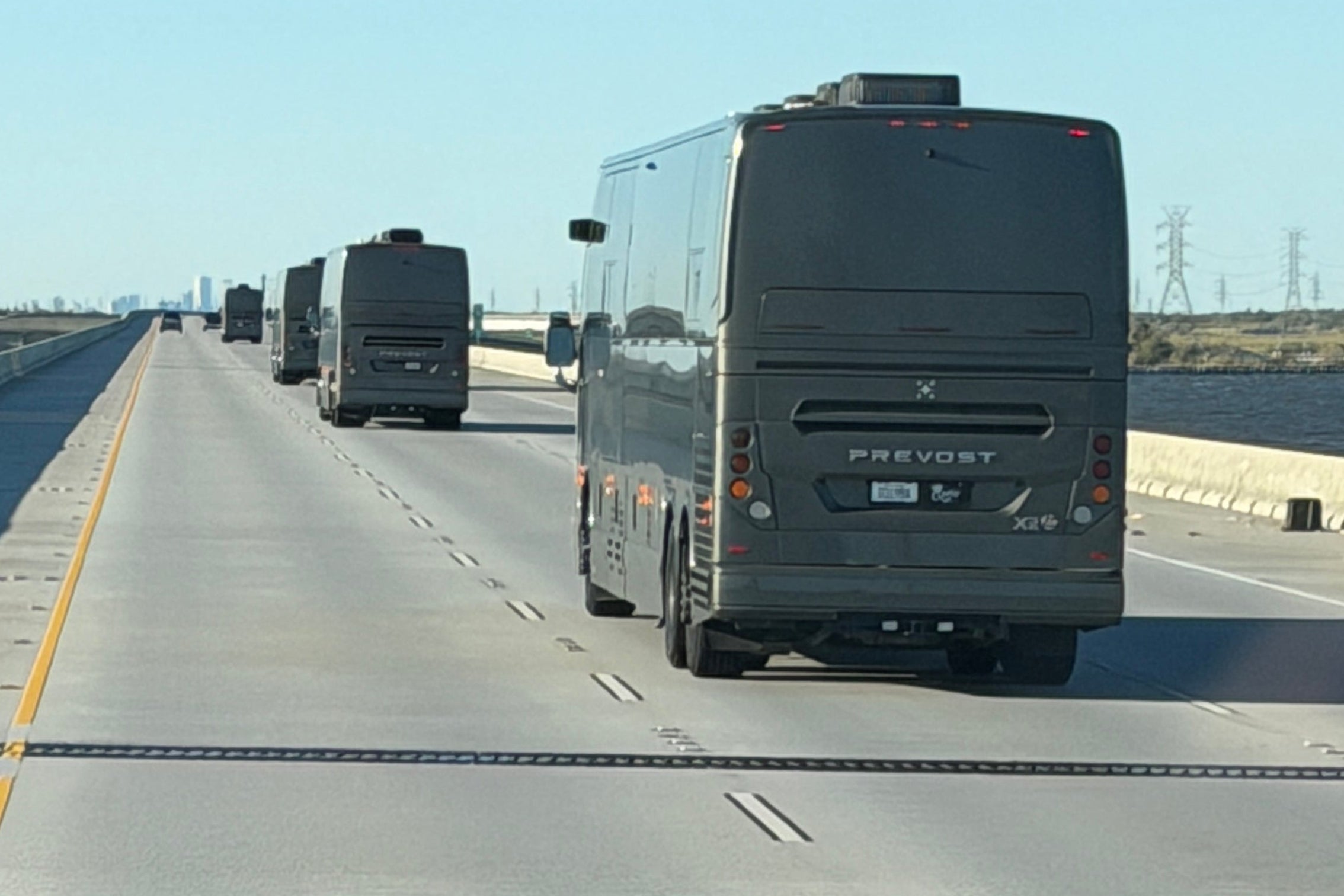 Long bus on a highway with clear sky